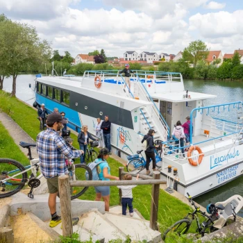 groupe de cycliste qui descend vers une péniche
